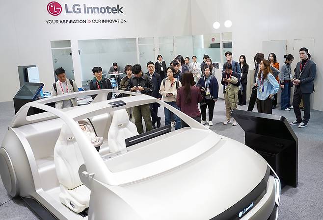 An autonomous concept vehicle mock-up stands at the center of LG Innotek’s exhibition booth at the CES 2026 tech show in Las Vegas. (LG Innotek)