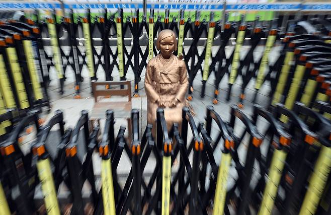 A statue of a girl symbolizing the victims of Japanese wartime sexual slavery, euphemistically referred to as comfort women, is seen with fences around it in front of the grounds of the former Japanese embassy to Korea in central Seoul on Dec. 28, 2025. [NEWS1]
