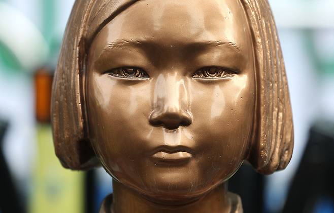 A statue of a girl symbolizing the victims of Japanese wartime sexual slavery, euphemistically referred to as comfort women, is seen in front of the grounds of the former Japanese embassy to Korea in central Seoul on Dec. 28, 2025. [YONHAP]