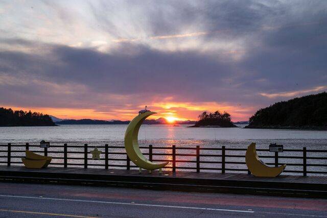 여자만 갯벌을 끼고 있는 소라면 장척리 해변 조형물 너머로 해가 기울고 있다.