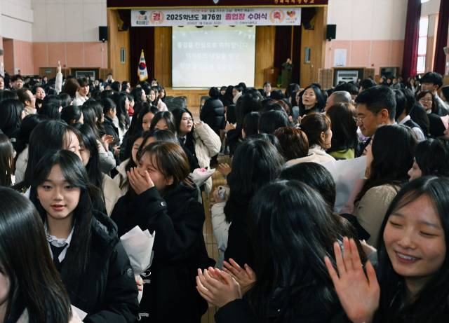 9일 창원시 진해구 진해여자중학교 체육관에서 열린 마지막 졸업식에서 졸업생들이 1·2학년 재학생들의 환송을 받으며 학교를 나서고 있다. /김승권 기자/