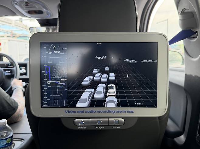 The rear-seat display shows vehicles, pedestrians, and obstacles as intuitive icons. [SARAH CHEA]