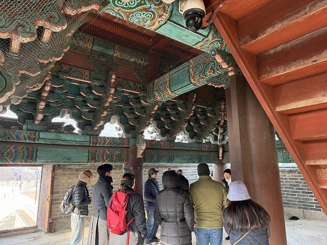 ▲&nbsp;성문 내부 천장에 화려한 단청 문양이 남아 있고, 방문객들이 문화해설사의 설명을 듣고 있다. /최준희 기자wsx3025@incheonilbo.com