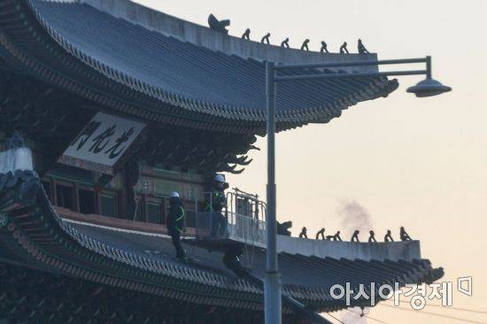 8일 오전 서울 종로구 광화문에서 인부들이 현판을 점검하고 있다. 광화문 현판은 지난 여름 색상 과학적 분석 연구를 위해 실물 크기 실험용 현판 촬영 작업을 진행 했다./강진형 기자aymsdream@