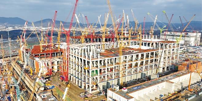 지난 15일 경기 용인 SK하이닉스 반도체 클러스터 공사 현장에서 100m 높이 골리앗 크레인이 1기 팹(공장) 골조를 올리고 있다. 1기 팹은 이르면 내년 2~3월 완공﻿된다.  이솔 기자