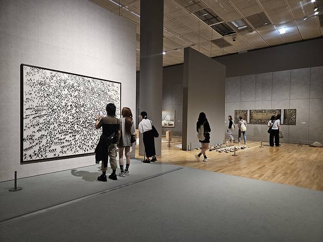 Visitors to the National Museum of Modern and Contemporary Art, Korea in Seoul look at works in the exhibition "MMCA Collection: Korean Contemporary Art" on July 18, 2025. (Park Yuna/The Korea Herald)