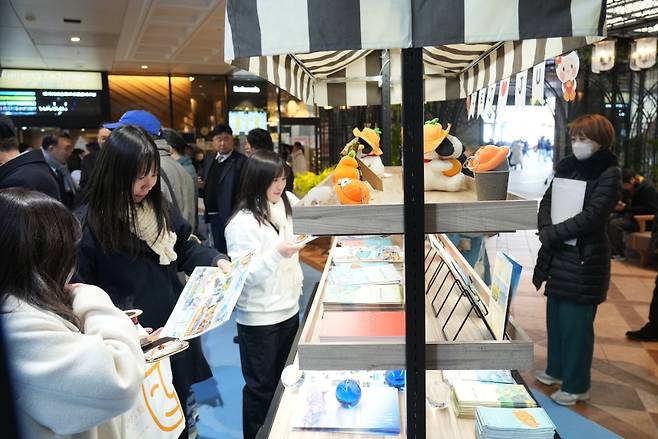 현지 방문객들이 제주 관광 콘텐츠와 안내 자료를 살펴보고 있다. (제주도청 제공)