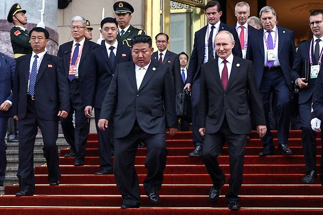 In this pool photograph distributed by the Russian state agency Sputnik, Russia's President Vladimir Putin (center right) and North Korea's leader Kim Jong-un (center left) leave after their meeting in Beijing on Sept. 3, 2025. Putin on Sept. 3 thanked Kim for sending troops to oust Ukrainian soldiers from Russia's Kursk border region, saying they fought ″heroically.″ [AFP/YONHAP]