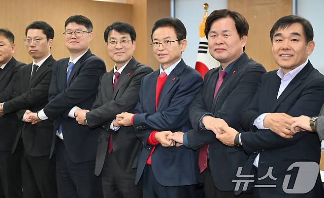 이철우 경북지사와 김정기 대구시장 권한대행(행정부시장)을 비롯한 대구·경북 관계자들이 20일 오후 경북 안동시 경북도청에서 열린 대구·경북 행정통합 추진협의 회의에서 손을 잡고 있다. (경북도 제공. 재판매 및 DB 금지) 2026.1.20/뉴스1 ⓒ News1 공정식 기자