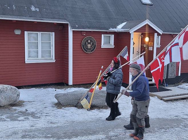 미국 영사관 앞에서 항의 시위하는 그린란드 주민들 (누크=연합뉴스) 현윤경 특파원 = 24일 그린란드 누크에 있는 미국 영사관 앞에서 그린란드 깃발을 든 주민들이 항의 행진을 하고 있다. 2026.1.25 ykhyun14@yna.co.kr