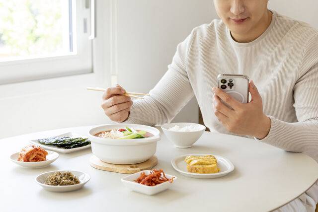 스마트폰을 보며 식사하는 행위는 과식을 부를 수 있다. 클립아트코리아