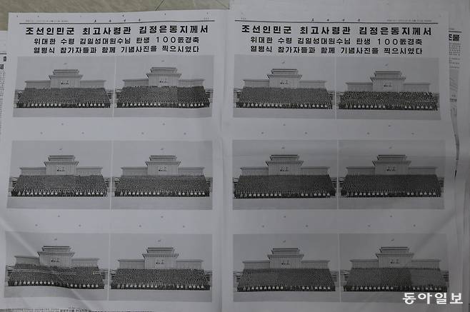 노동신문 2012년 4월 21일 5면과 6면 .  김정은이 행사 참가자들과 찍은 기념사진이 신문 지면 전체에 게재되어 있다. 집권초기 김정은은 엄청난 양의 기념사진을 쏟아냈었다. 집권 15년차인 올해와 작년 이런 식의 사진이 현저히 줄고 김정은 개인을 부각하는 사진이 발전하고 있다. 동아일보 DB.