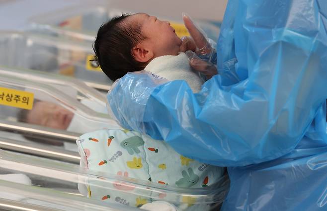 A baby is tended to by a nurse at a hospital in Goyang, Gyeonggi, on Nov. 26, 2025. [YONHAP]