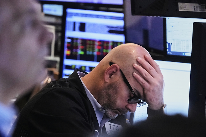 21일(현지시간) 미국 뉴욕증권거래소(NYSE)에서 한 트레이더가 고개를 푹 숙이고 있다. [AP]