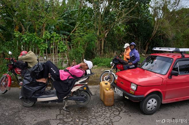 [바쿠라나오=AP/뉴시스] 30일(현지 시간) 쿠바 아바나 인근 바쿠라나오에서 주유하려는 운전자들이 주유소에 들어가기 위해 기다리고 있다. 쿠바에 대한 베네수엘라와 멕시코의 원유 수출이 중단되면서 쿠바 주유소에는 기름을 넣으려는 운전자들이 몇 시간씩 줄을 서고 있다. 2026.01.31. /사진=민경찬