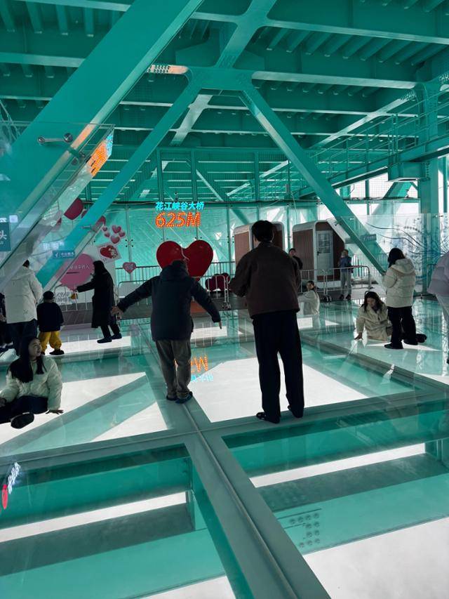 3일 관광객들이 화장협곡대교의 투명 유리 바닥 위를 걸으며 즐거워하고 있다. 안순(구이저우성)=이혜미 특파원