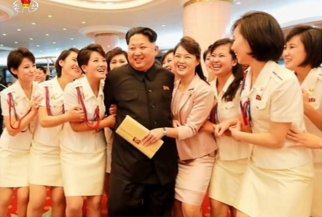 김정은 북한 국무위원장이 모란봉악단 단원들 사이에서 웃으며 대화를 나누고 있다. 조선중앙TV 연합뉴스