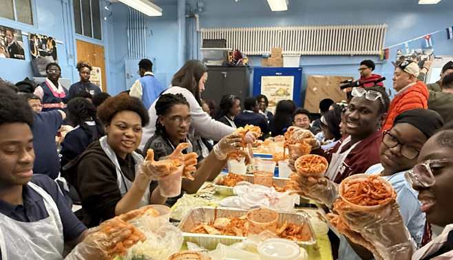 뉴욕 데모크라시 프렙 고등학교 학생들이 한국 설을 맞아 김치 담그기 체험에 참여해 직접 만든 김치를 들어 보이고 있다. (aT 제공)