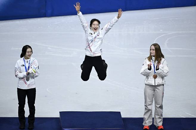 김길리(가운데)가 펄쩍 뛰며 시상대 가장 맨 윗자리에 오르고 있다. 왼쪽이 최민정.(사진=AFPBBNews)