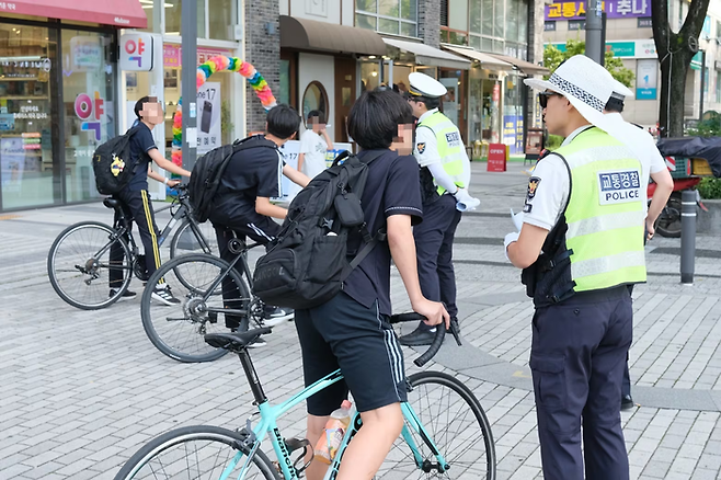 지난해 9월 15일 오후 서울 강동구 고덕역 인근에서 경찰이 학생들에게 픽시자전거 탑승 행위에 주의를 당부하고 있다. [뉴스1]