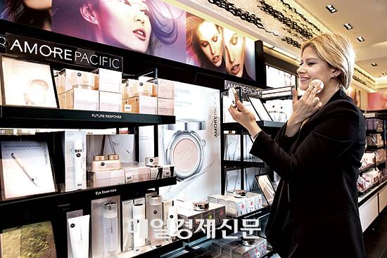 미국 뉴욕 소재 화장품 편집숍 ‘세포라’에서 한 고객이 아모레 퍼시픽의 쿠션 화장품을 발라 보고 있다. [매경DB]