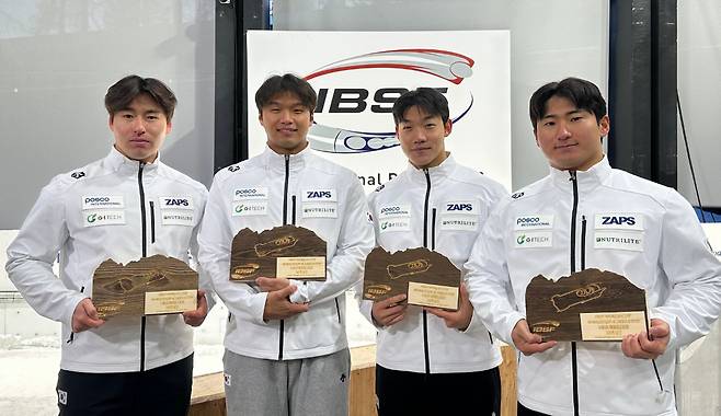 Kim Jin-su, first from left, poses for a commemorative photo with his teammates after the IBSF World Cup's four-man bobsleigh race in Italy in November 2025. [KOREAN BOBSLEIGH SKELETON FEDERATION]