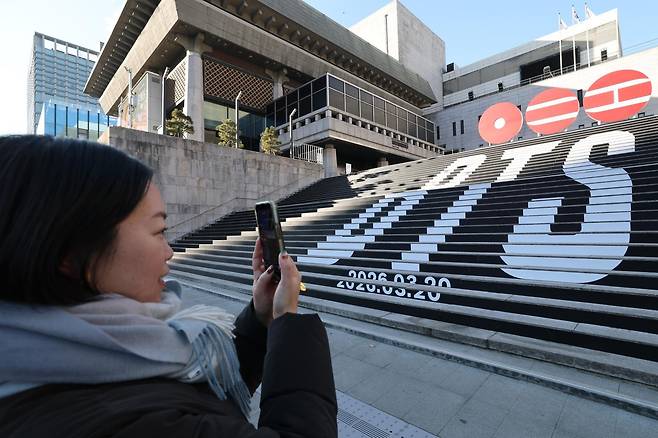 6일 오전 서울 종로구 세종문화회관 야외 계단에 설치된 BTS(방탄소년단)의 컴백 로고 조형물 앞에서 관광객이 기념촬영을 하고 있다. 뉴스1