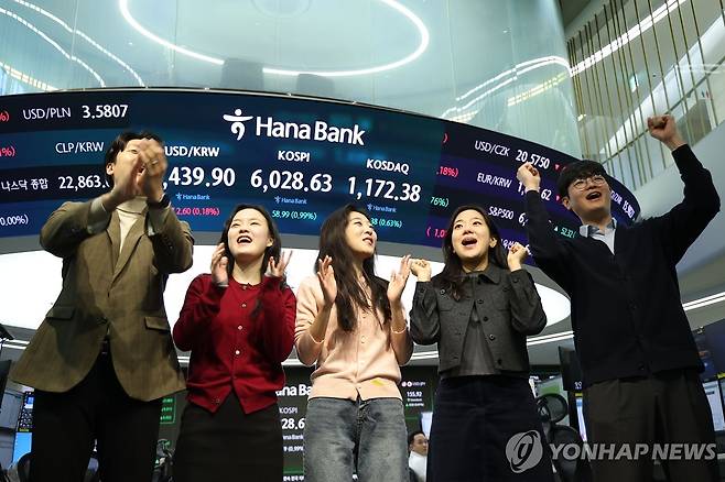 이제 코스피 6000 시대 (서울=연합뉴스) 김성민 기자 = 코스피가 장중 6000을 넘어선 가운데 25일 서울 중구 하나은행 본점 딜링룸에서 직원들이 기뻐하고 있다. 
    이날 코스피는 전 거래일보다 53.06포인트(0.89%) 오른 6,022.70로 개장해 사상 처음으로 6,000선을 돌파했다. 2026.2.25 ksm7976@yna.co.kr