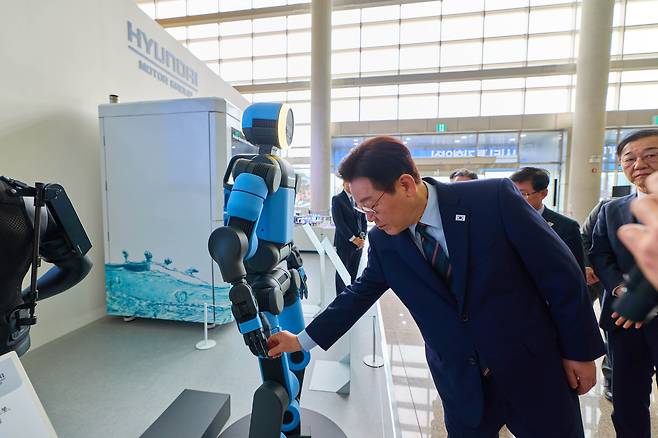 이재명 대통령이 27일 오전 전북 군산 새만금컨벤션센터에서 열린 '새만금 로봇·수소·AI시티 투자협약식'에서 휴머노이드 로봇 아틀라스를 살펴보고 있다./뉴시스