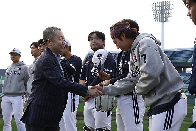 박정원 두산 구단주(왼쪽)가 25일 일본 미야자키 스프링 캠프 현장에서 박찬호와 악수하고 있다. 두산베어스 제공