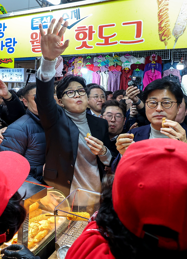 한동훈 전 국민의힘 대표가 대구 서문시장에서 지지자들에게 손을 흔들고 있다. <연합뉴스>