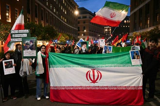 지난 3일(현지시간) 이탈리아 로마 주재 미국대사관 인근에서 이란 국민들이 피살된 최고지도자 아야툴라 알리 하메네이의 사진과 이란 국기를 들고 시위를 하고 있다. AFP연합뉴스