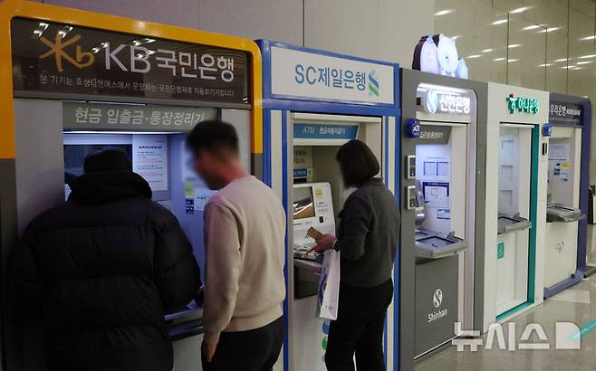 [서울=뉴시스] 조성우 기자 = 12일 서울 시내의 한 건물에서 시민들이 시중은행 ATM기기를 이용하고 있다.KB·신한·하나·우리·NH농협 등 5대 금융그룹은 지난해 당기순이익 20조 4700억 원을 기록하며 사상 처음으로 '20조 원 시대'를 열었다. 이는 전년(18조 8742억 원) 대비 1조 5958억 원(8.45%) 증가한 규모다. 2026.02.12. xconfind@newsis.com
