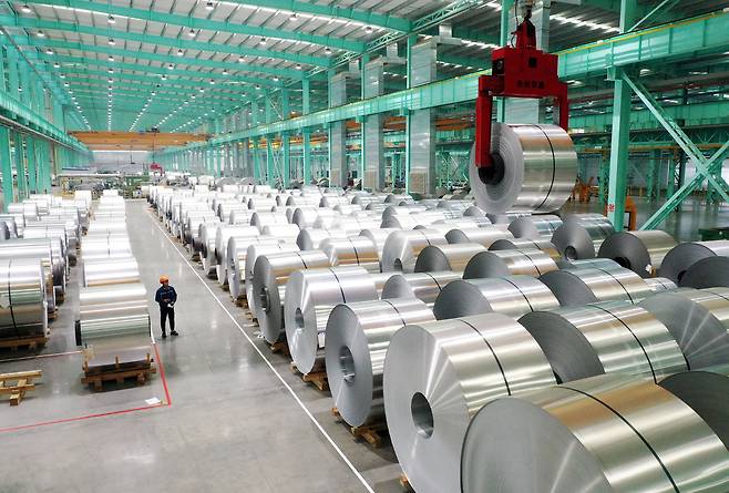A drone view shows an employee working on the production line of aluminium products at a factory in Huaibei, Anhui province, China, on Feb. 11, 2025, in this photo provided by China Daily. [REUTERS/YONHAP]