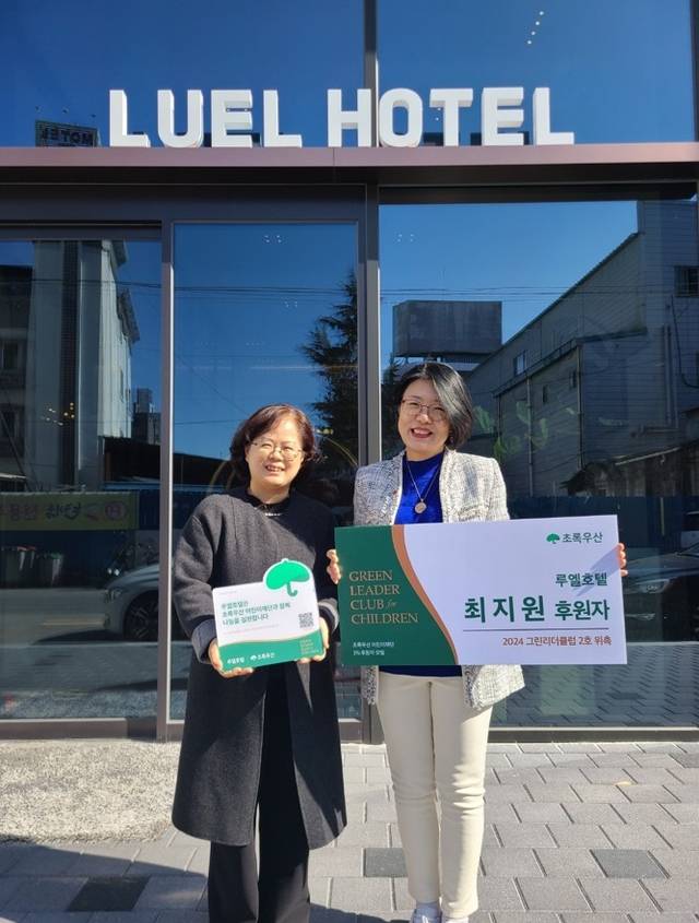 최지원(오른쪽) 씨가 2024년 자신이 운영하는 호텔 앞에서 그린리더클럽 위촉식을 진행하고 있다.  초록우산 제공