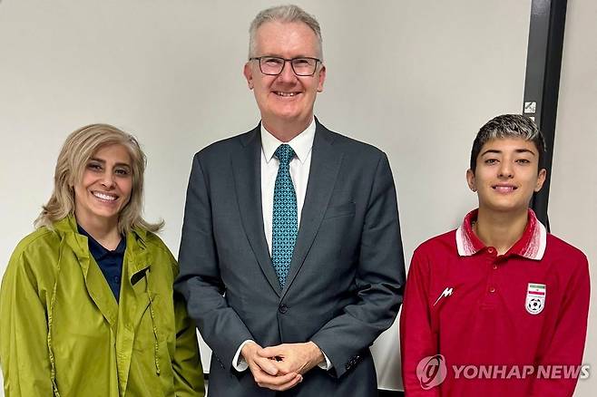 호주에 망명한 이란 여자축구대표팀 소속 2명과 토니 버크 호주 내무부 장관 (브리즈번[호주] AFP=연합뉴스) 11일(현지시간) 호주 동부 브리즈번에서 토니 버크 호주 내무부 장관(가운데)이 이란 여자축구대표팀 소속 2명과 만나 이들에게 호주 망명을 위한 인도주의 비자를 발급해준 뒤 함께 찍은 사진.