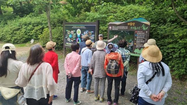 달성투어버스 송해공원 코스에서 관광객들에게 해설사가 관광지를 소개하고 있다. 달성군 제공