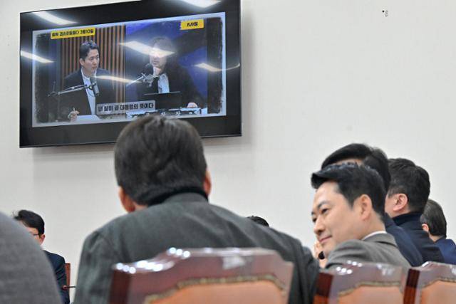국민의힘 지도부가 12일 국회에서 열린 최고위원회의 도중 '이재명 대통령 공소 취소 거래설'과 관련한 '김어준의 겸손은 힘들다 뉴스공장' 자료 화면을 시청하고 있다. 오른쪽 부분 유일하게 얼굴이 보이는 인물은 장동혁 국민의힘 대표다. 민경석 기자
