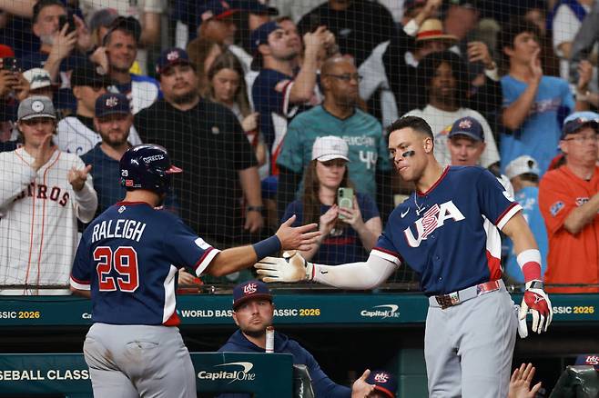 HOUSTON, TEXAS - MARCH 13: Cal Raleigh #29 celebrates his score with Aaron Judge #99 of Team United States during the sixth inning against Team Canada at Daikin Park on March 13, 2026 in Houston, Texas.  AFP연합뉴스