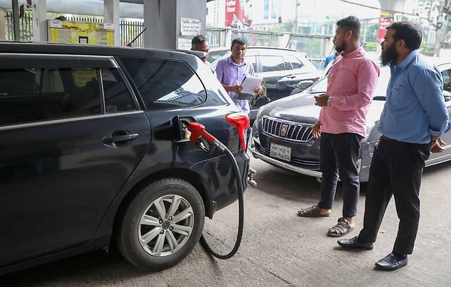 8일 방글라데시 다카의 한 주유소에서 한 직원이 자동차에 연료를 공급하고 있다. /연합뉴스