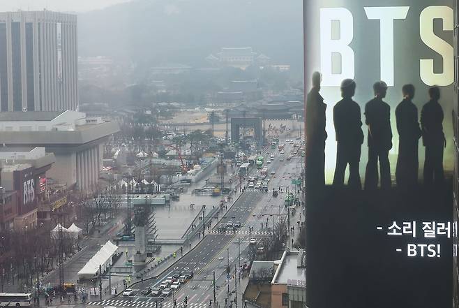 방탄소년단(BTS) 완전체 컴백 공연을 사흘 앞둔 18일 서울 광화문광장 인근 빌딩 전광판에 컴백 공연을 알리는 광고가 표출되고 있다. 정부는 이날 방탄소년단(BTS) 광화문 공연을 앞두고 19일 0시부터 21일 밤 12시까지 종로구와 중구 등 도심 일대 테러경보를 기존 '관심'에서 '주의'로 상향 발령한다고 밝혔다. 뉴스1