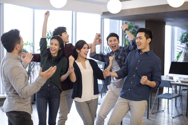 Young abroad students cheering in classroom