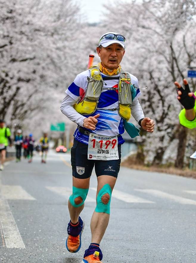 김휘율 교수가 지난해 4월 충북 청주에서 열린 청남대울트라마라톤 100km에 출전해 질주하고 있다. 2008년 10km 단축 마라톤 출전을 계기로 달리기에 빠진 김 교수는 주중 1회 혼자 달리고 금요일에 아이스하키, 토요일에 등산, 일요일에 마라톤 훈련이나 대회 출전이라는 루틴을 지키고 있다 .김휘율 교수 제공