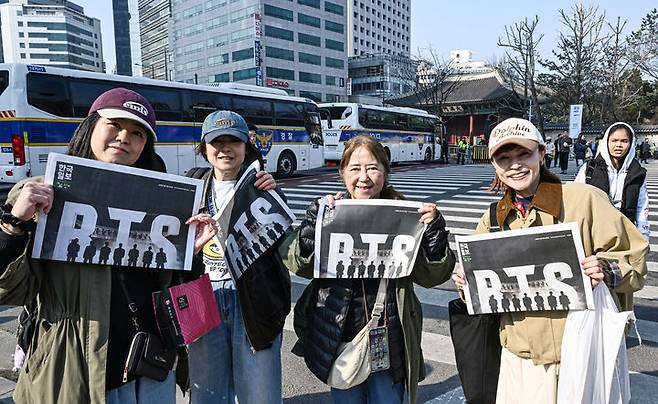 [서울=뉴시스] 그룹 방탄소년단(BTS) 컴백 공연을 앞둔 21일 서울 광화문 일대에서 일본인 관광객들이 한국일보가 발행한 BTS 특별판을 들어 보이고 있다. (사진=한국일보 제공) 2026.03.21. photo@newsis.com *재판매 및 DB 금지