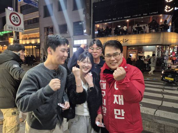 이재만 국민의힘 대구시장 예비후보가 대구 도심에서 만난 청년들과 기념 촬영을 하고 있다. 이 예비후보 캠프 제공