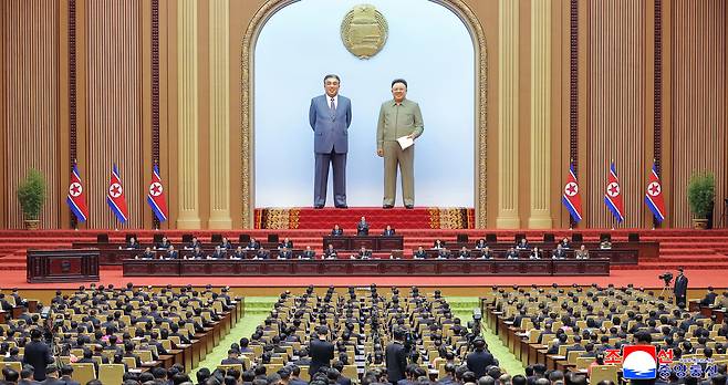 North Korean leader Kim Jong-un, center in the second row from back, presides over the first-day session of the 15th Supreme People’s Assembly in Pyongyang on March 22, where he was reappointed as chairman of the state affairs commission, in this photo carried by the Korean Central News Agency on March 23. [YONHAP]