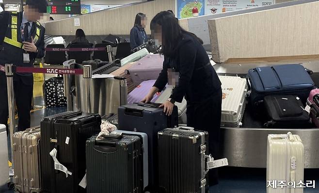 제주공항 국제선 도착장 수하물 컨베이어 벨트에서 한 항공사 직원이 캐리어를 정리하고 있다. ⓒ제주의소리