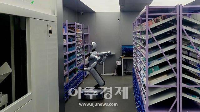 베이징 하이뎬구 중관춘의 한 콘택트렌즈 전문점에서 갤봇 휴머노이드 로봇이 주문 접수 후 매대에서 제품을 꺼내고 있다. [사진=배인선 특파원]