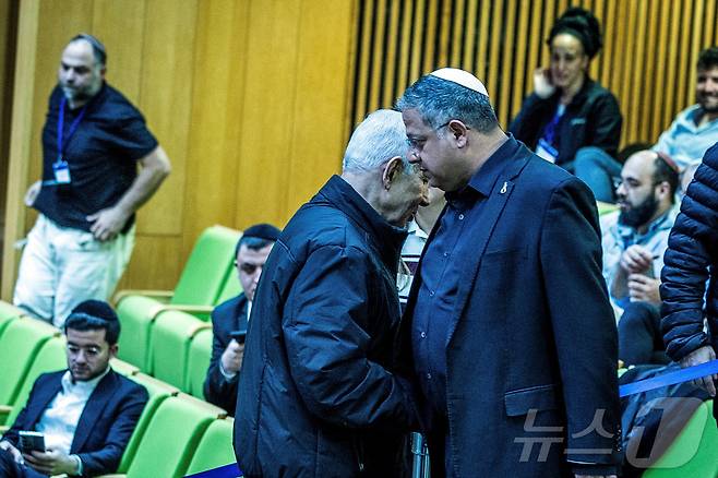 이스라엘 총리 베냐민 네타냐후와 극우 성향의 국가안보부 장관 이타마르 벤그비르가 29일(현지시간) 예루살렘 크네세트(이스라엘 의회) 회의에서 악수하고 있다.2026.03.29. ⓒ 로이터=뉴스1