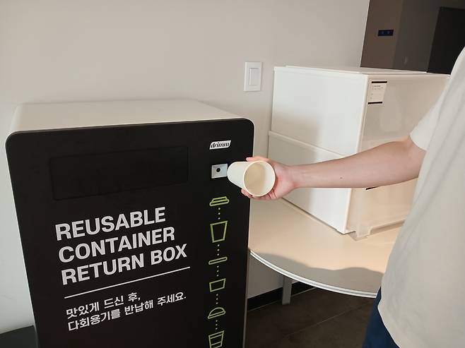 ▲서울물재생시설공단 직원이 다 쓴 다회용컵을 반납기에 반납하고 있다. 사진=윤병효 기자